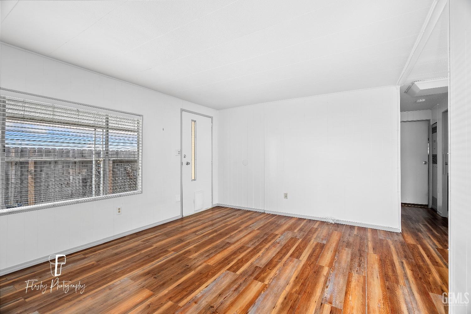 Undisclosed Address Bakersfield, CA 93301 - Photo 8 of 27 a view of empty room with wooden floor and fan