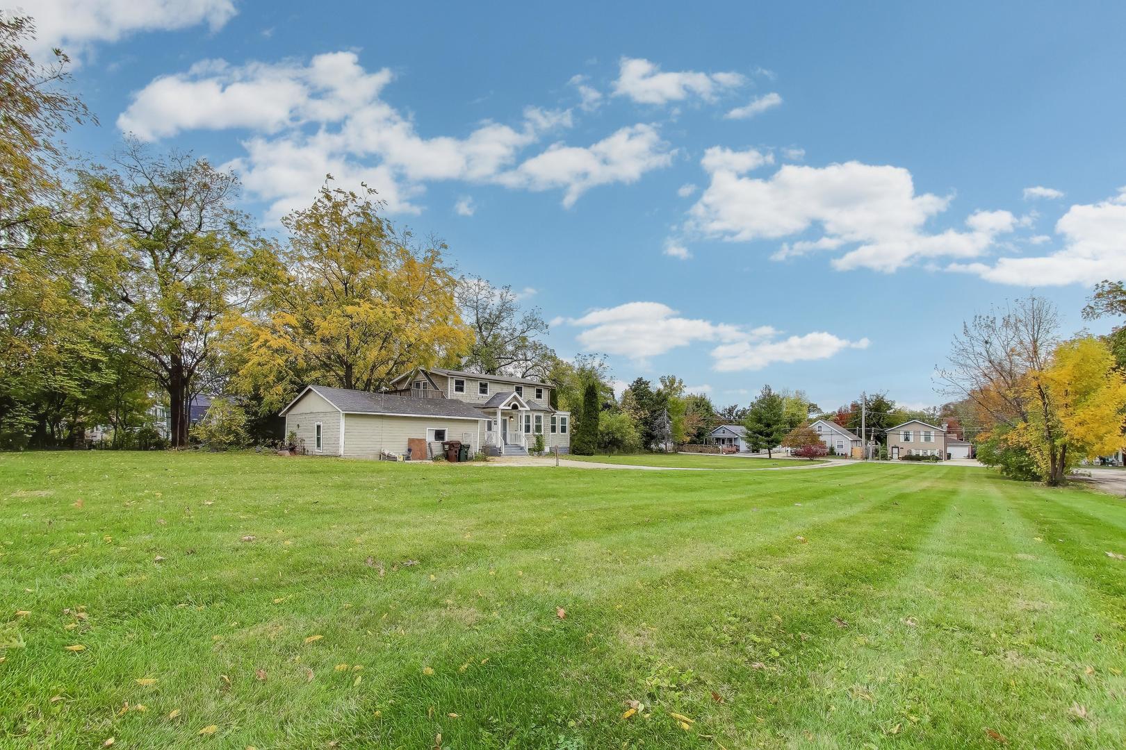 207 Shady Lane Mundelein, IL 60060 - Photo 3 of 28 a view of a big yard with plants and large trees