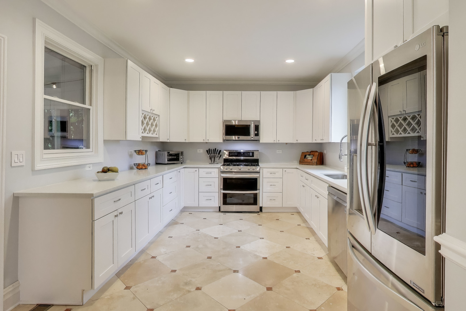 207 Shady Lane Mundelein, IL 60060 - Photo 9 of 28 a kitchen with white cabinets and stainless steel appliances