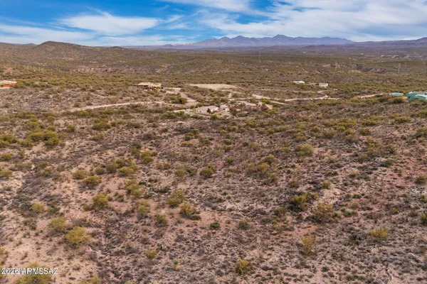 a view of a large mountain with mountains in the background