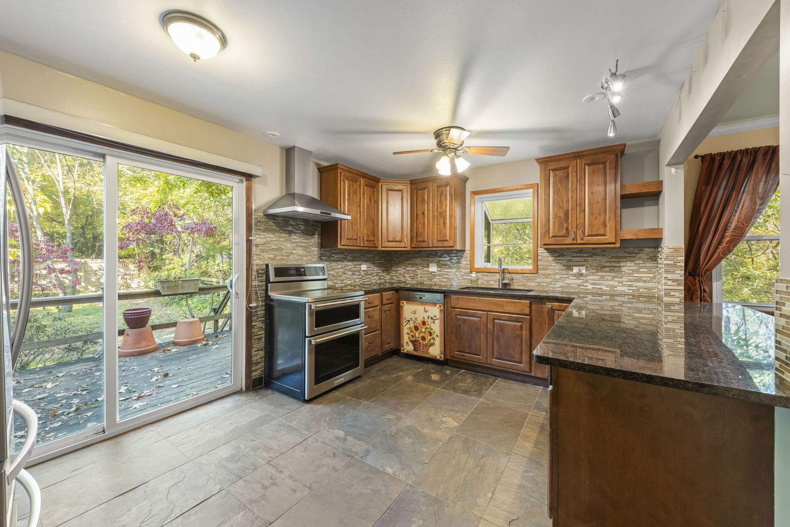 18000 Armitage Court Homewood, IL 60430 - Photo 7 of 23 a kitchen with stainless steel appliances granite countertop a refrigerator a sink dishwasher a stove and a large window with wooden floor