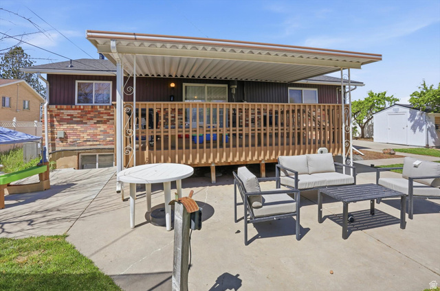 5108 South 2000th Street West Roy, UT 84067 - Photo 56 of 61 View of patio / terrace with outdoor seating and a shed