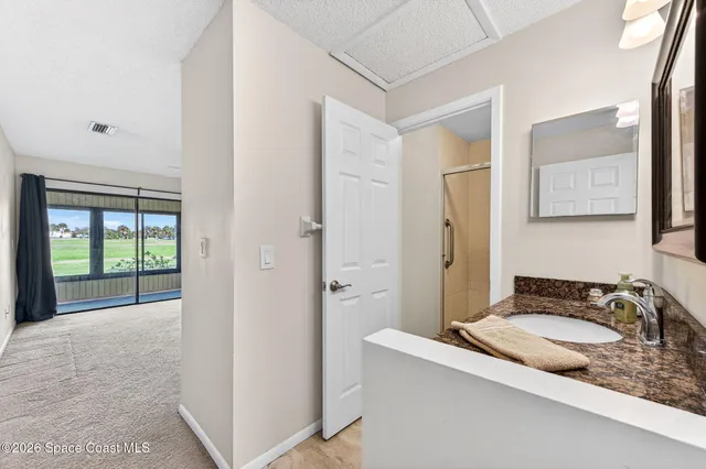 a kitchen with kitchen island a sink cabinets and stainless steel appliances