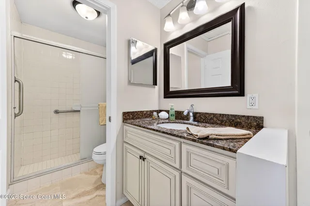 an empty room with window and ceiling fan