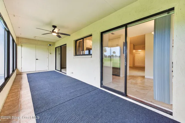 a view of an empty room with windows