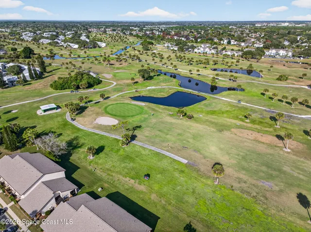 a view of a street with potted plants