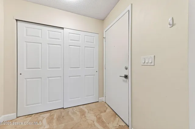 a living room with furniture a chandelier and a window