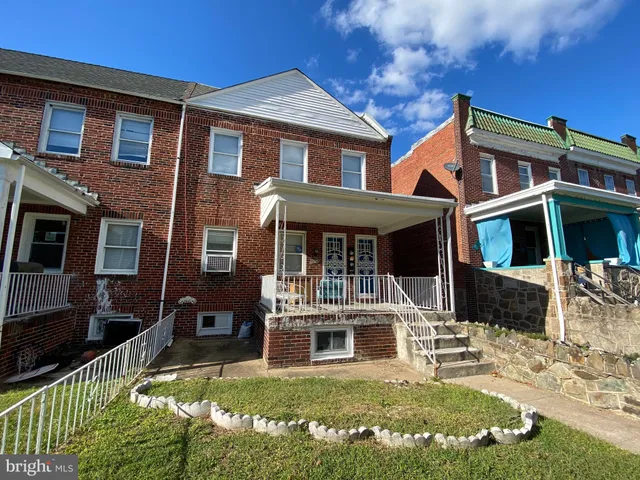 a front view of a house with a yard table and chairs