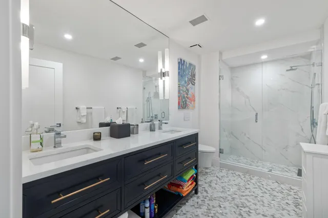 a bathroom with a double vanity sink mirror double shower and a bathtub