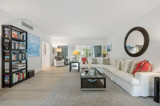 a living room with furniture and a book shelf