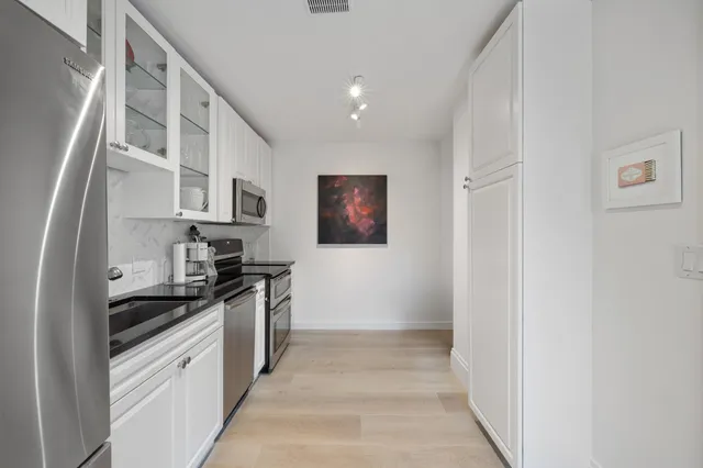 a kitchen with stainless steel appliances a sink and a stove top oven