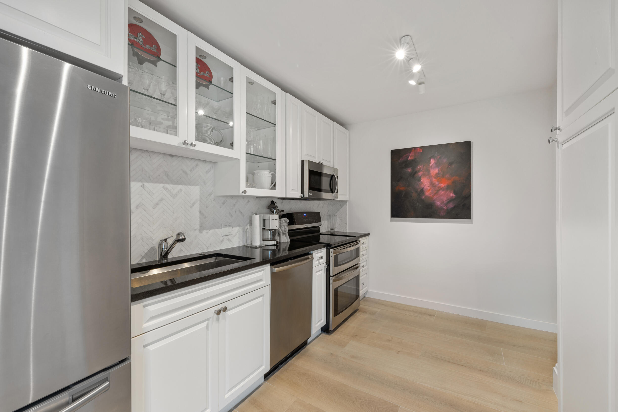 300 South Ocean Boulevard, Unit 3G Palm Beach, FL 33480 - Photo 9 of 25 a kitchen with stainless steel appliances granite countertop a refrigerator and a stove top oven