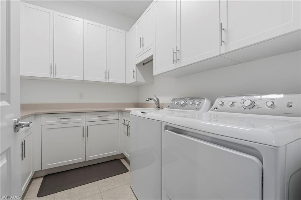 12083 Azalea Way Naples, FL 34120 - Photo 30 of 48 Spacious Laundry room with built-in cabinets and laundry sink.