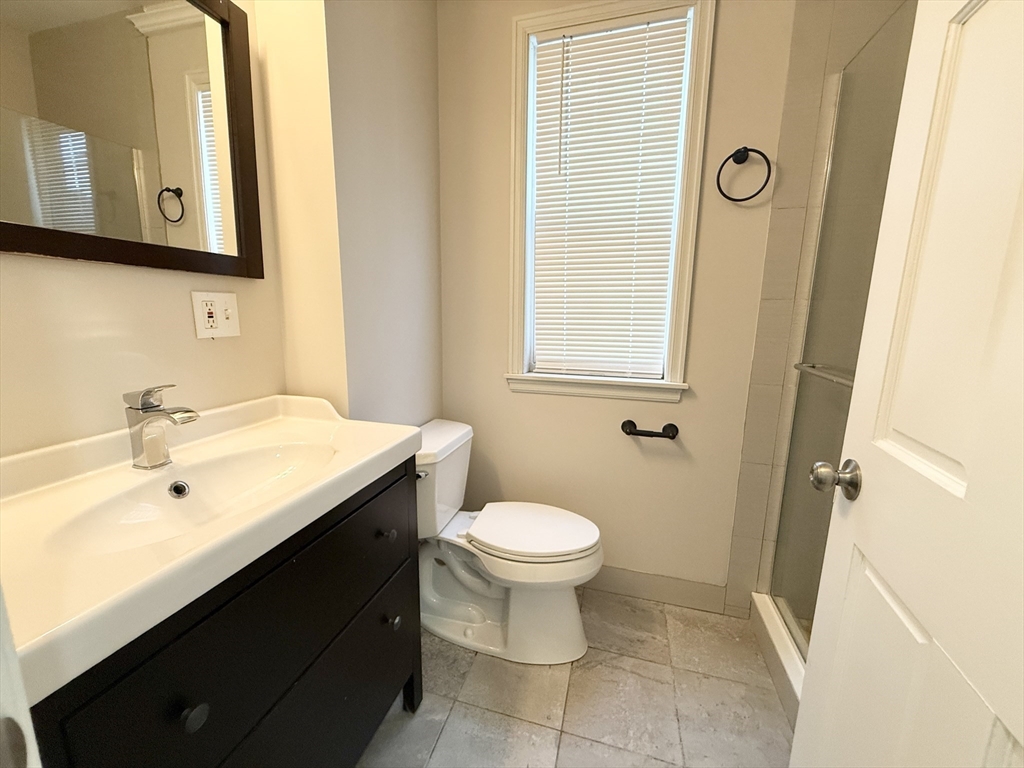 71 Saxton Street, Unit 2 Boston, MA 02125 - Photo 9 of 10 a bathroom with a sink toilet and shower