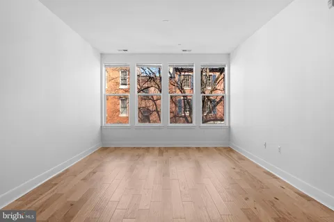a view of room with window and hardwood floor