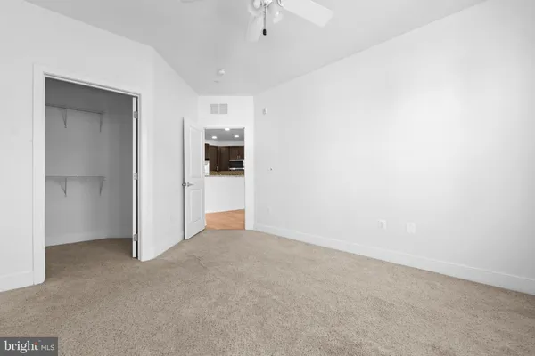 an empty room with windows and painted walls