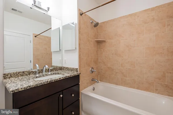 a bathroom with a bathtub and shower