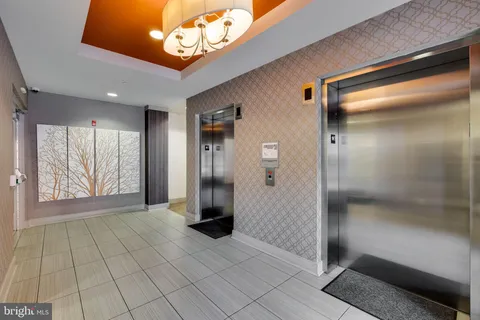 a bedroom with furniture and painting on the wall