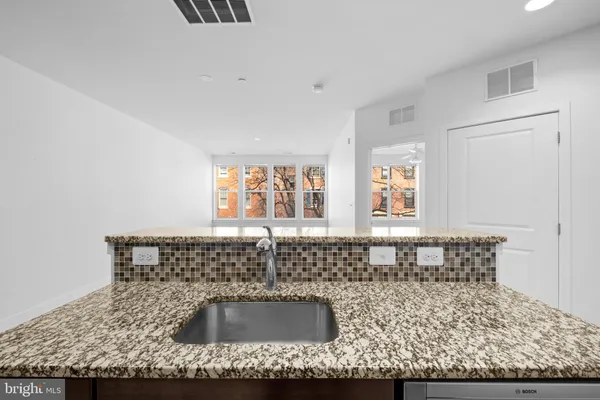 a kitchen with a sink and cabinets