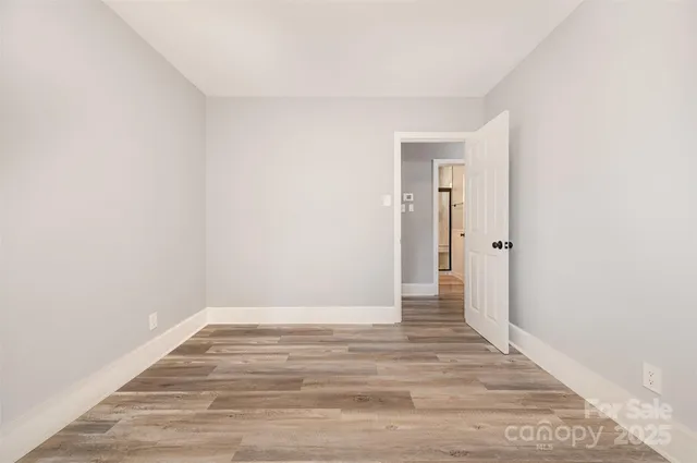 a view of a room with wooden floor