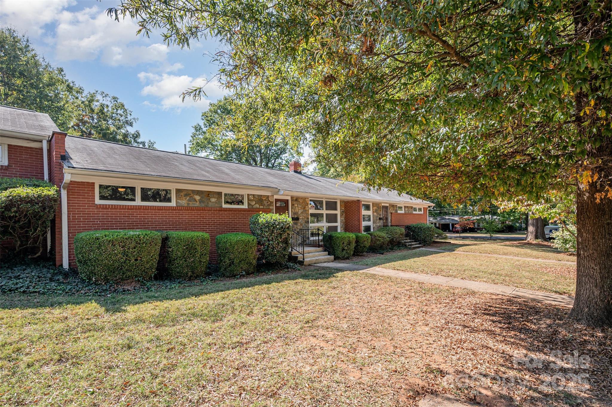 1015 Andover Road Charlotte, NC 28211 - Photo 2 of 22 a front view of a house with a yard and garage