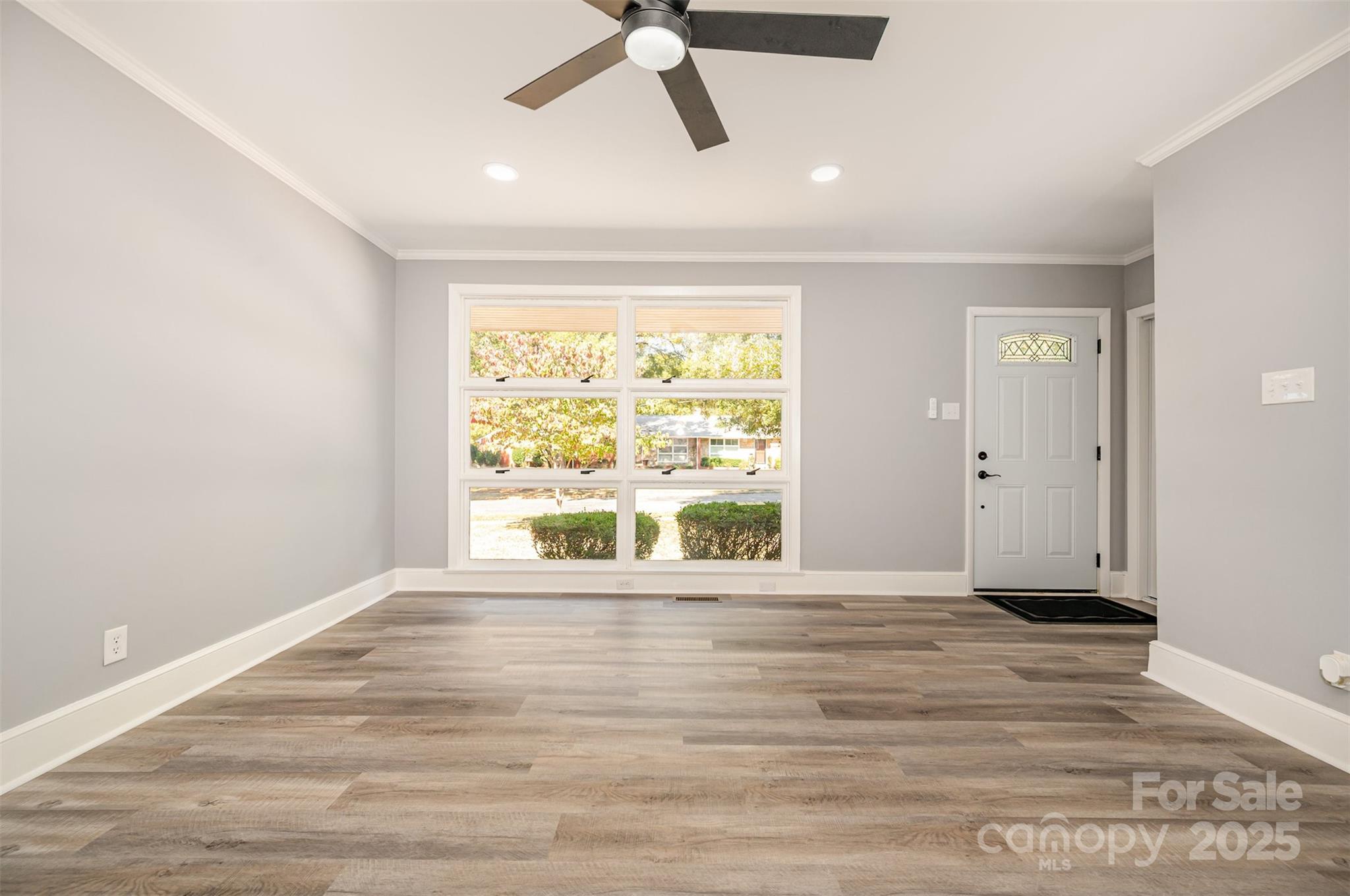 1015 Andover Road Charlotte, NC 28211 - Photo 6 of 22 an empty room with wooden floor and windows