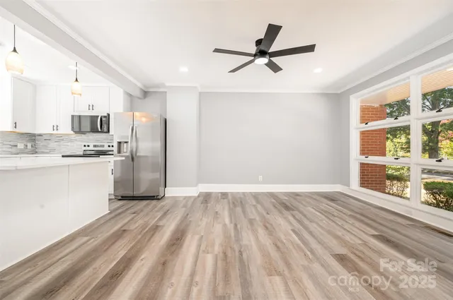a view of a kitchen with a sink refrigerator and window