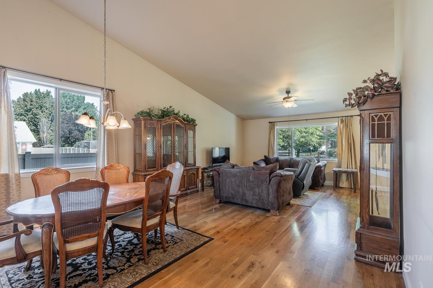 1186 East Observation Street Meridian, ID 83642 - Photo 9 of 33 Vaulted ceilings with a ceiling fan in the living area and a chandelier in the dining area