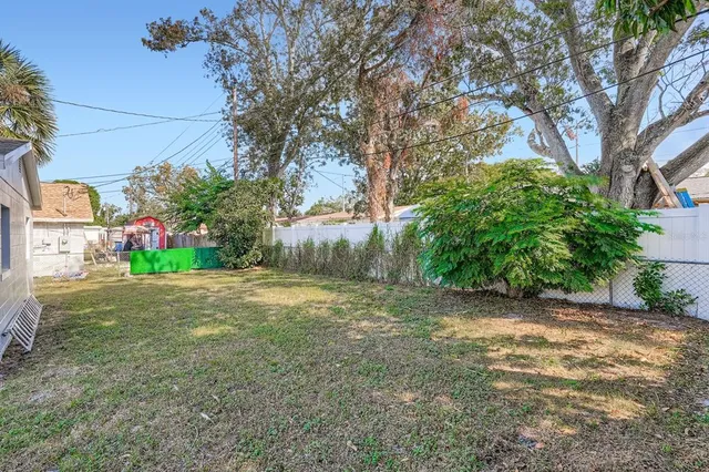 a view of a yard with a house and trees