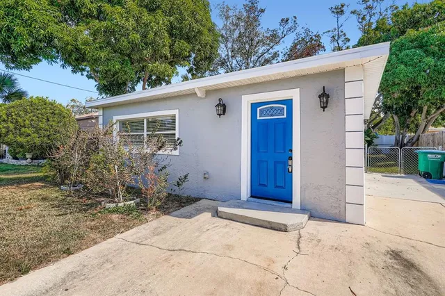 a view of house with backyard and garden