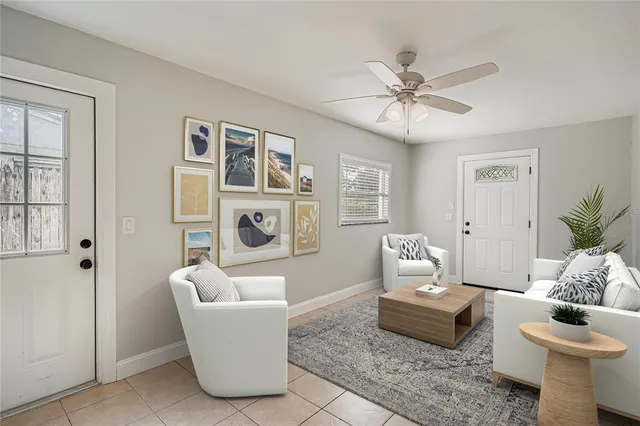 a living room with furniture and a potted plant