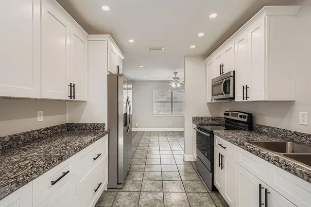 a kitchen with stainless steel appliances granite countertop a stove and a sink