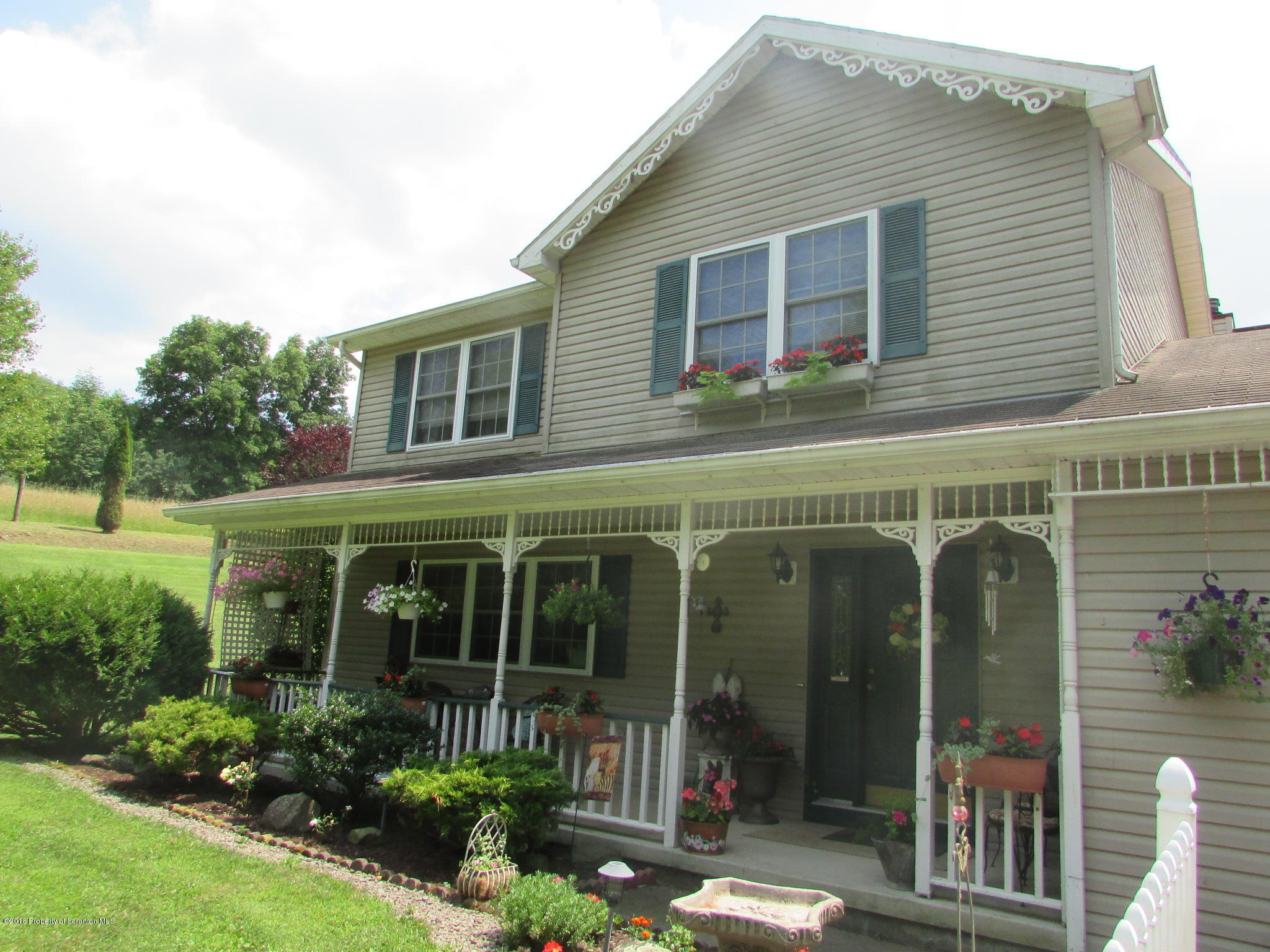 8840 State Rte 3001 Meshoppen, PA 18630 - Photo 2 of 64 a front view of a house with garden