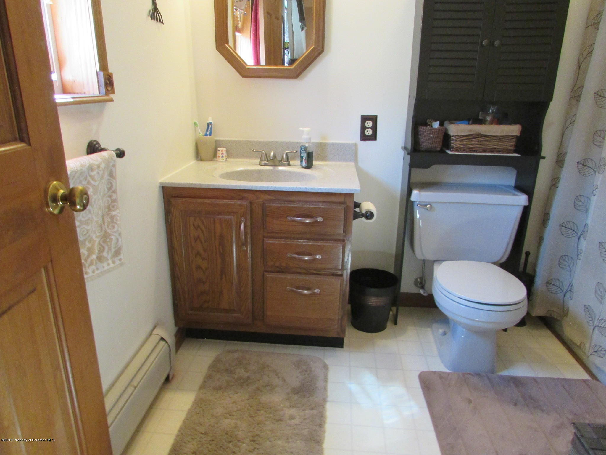 8840 State Rte 3001 Meshoppen, PA 18630 - Photo 39 of 64 a bathroom with a toilet a sink and a mirror