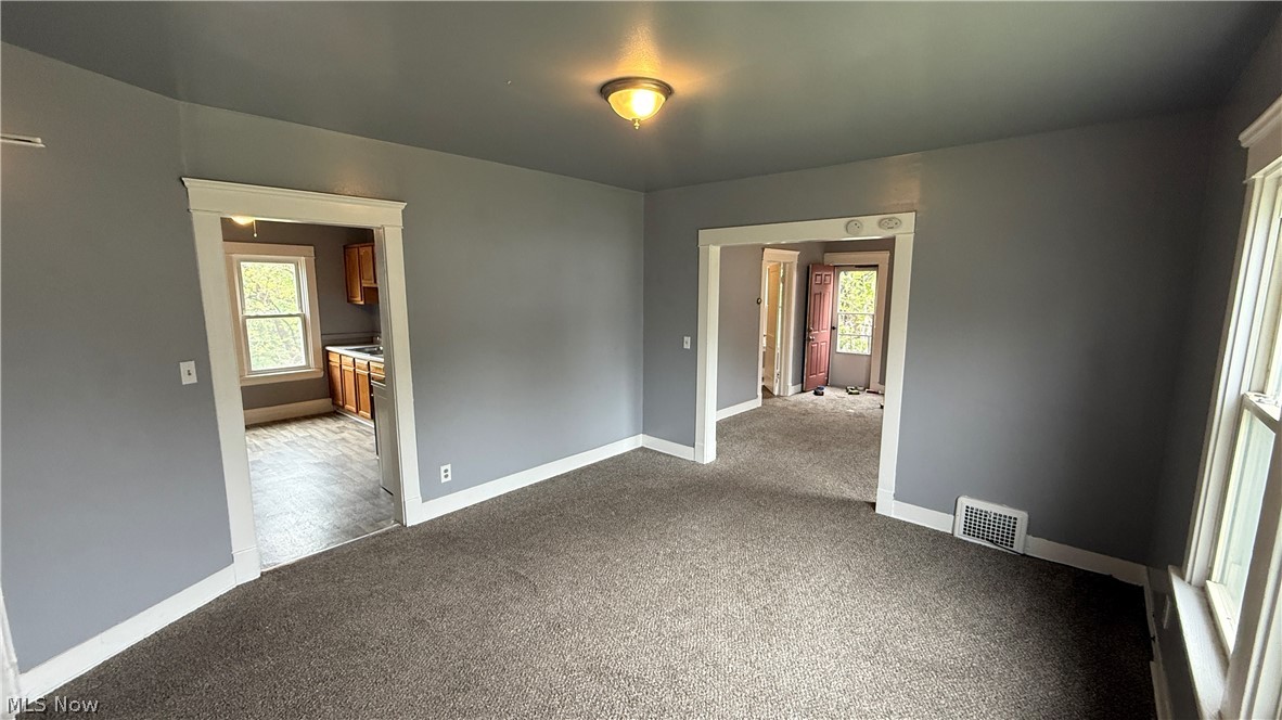 1187 Addison Road, Unit 4 Cleveland, OH 44103 - Photo 9 of 15 Spacious room featuring gray wall paint, dark carpet flooring, and white trim