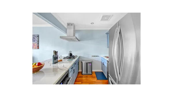 a hallway with a white stove next to a white cabinet