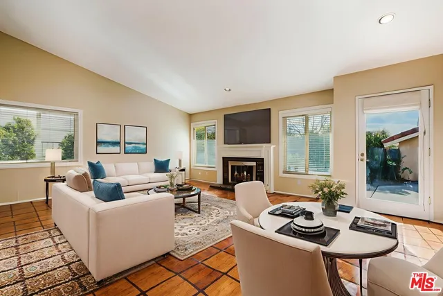 a living room with furniture a fireplace and a table