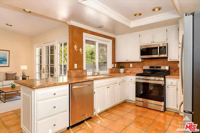 a bathroom with a granite countertop sink toilet a mirror and shower