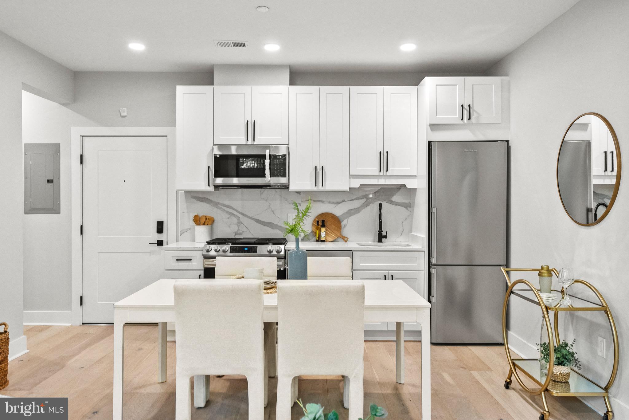 2019 M Street Northeast, Unit 1 Washington, DC 20002 - Photo 5 of 31 a kitchen with stainless steel appliances granite countertop a refrigerator and microwave