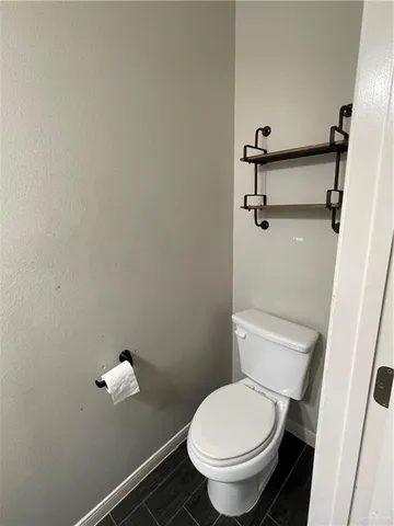 a white toilet sitting next to a shower