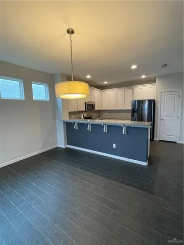 a view of kitchen with wooden floor and window