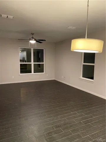 a view of a room with a sink and chandelier fan