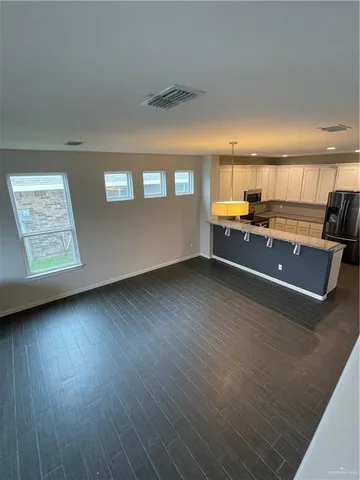 a view of a room with window and wooden floor