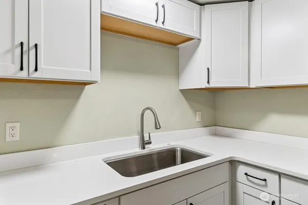 a kitchen with a sink and cabinets