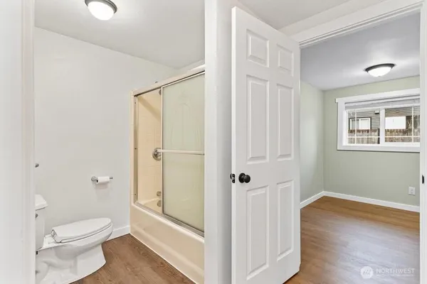 a bathroom with a toilet a sink and shower