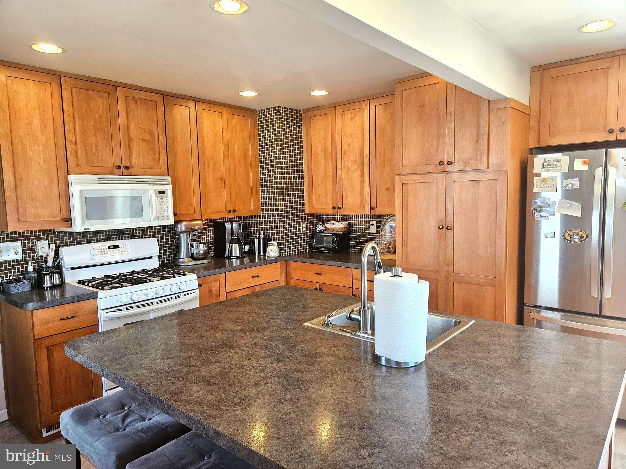 356 West Signal Hill Road King of Prussia, PA 19406 - Photo 8 of 28 a kitchen with a refrigerator and a stove top oven