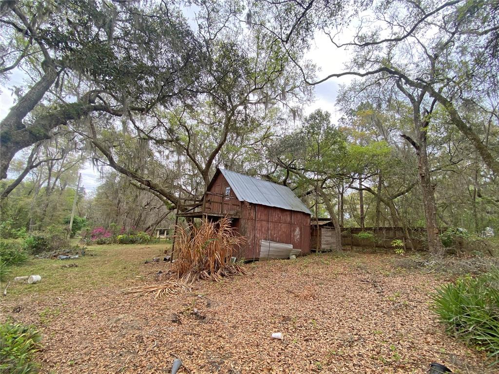 119 Twin Lakes Road Hawthorne, FL 32640 - Photo 27 of 66 a view of a house with a yard tree and a tree