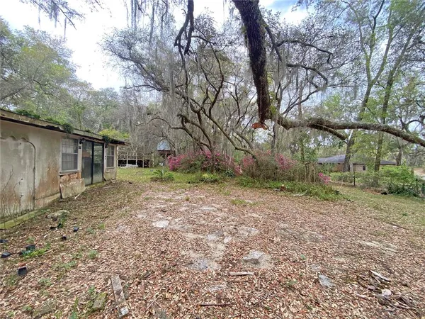 a backyard of a house with a yard and outdoor seating