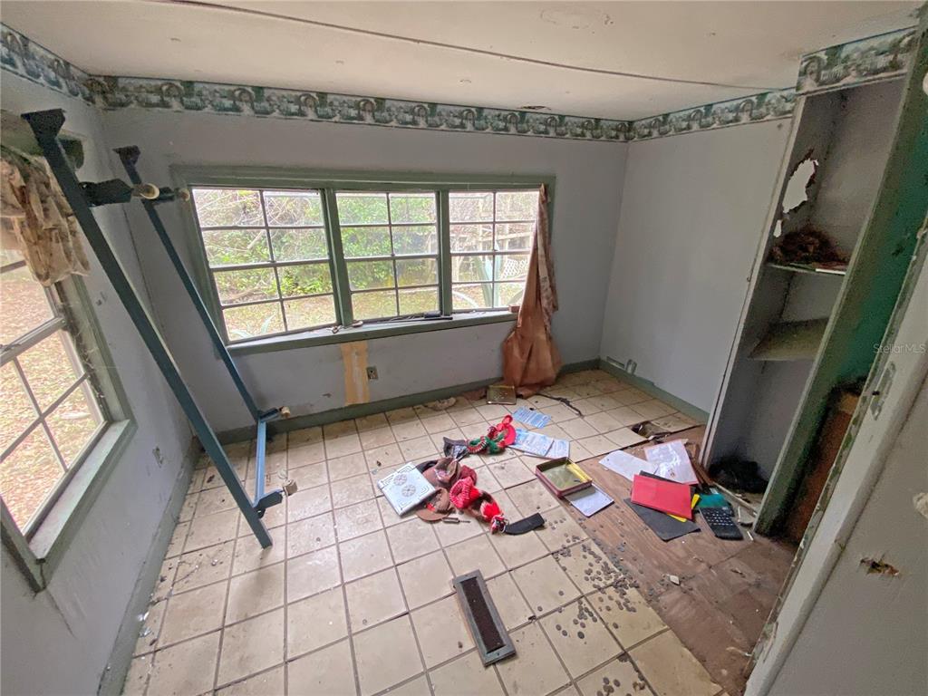 119 Twin Lakes Road Hawthorne, FL 32640 - Photo 56 of 66 a living room with furniture and a floor to ceiling window