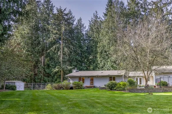 a front view of house with yard and green space